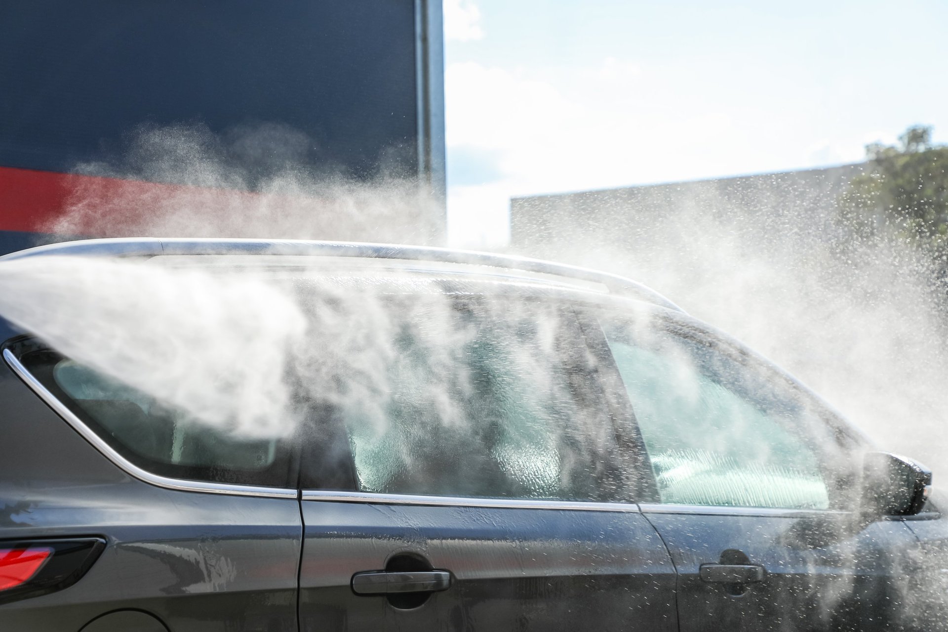 Luxury car being detailed with water and foam